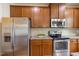 This kitchen features stainless steel appliances, granite countertops, and wood cabinets at 360 Callandale Ln, Durham, NC 27703