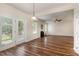 Open-concept living room with a fireplace and wood floors at 360 Callandale Ln, Durham, NC 27703