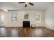 Bright living room featuring a fireplace, windows, and wood floors at 360 Callandale Ln, Durham, NC 27703