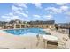 Community pool featuring lounge seating and chairs at tables around the pool at 360 Callandale Ln, Durham, NC 27703