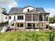 Rear exterior of a two-story home with a screened porch, patio, and well-maintained lawn at 3832 Noremac Dr, Raleigh, NC 27612