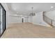 A large basement area with stairs, hardwood floors and a modern light fixture at 3832 Noremac Dr, Raleigh, NC 27612