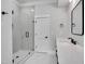 Bathroom with white tile shower, white vanity with black hardware, and modern mirror at 3832 Noremac Dr, Raleigh, NC 27612
