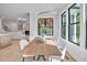 Cozy dining room with modern chandelier, natural wood table and large windows with nature view at 3832 Noremac Dr, Raleigh, NC 27612