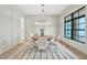 Bright dining room featuring a round table and six chairs, with a view to the foyer at 3832 Noremac Dr, Raleigh, NC 27612