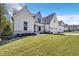 Stunning modern farmhouse with white siding, stone accents, and a well-manicured lawn at 3832 Noremac Dr, Raleigh, NC 27612