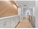 Hallway features wood accent wall, built-in storage, hardwood floors, and modern railing at 3832 Noremac Dr, Raleigh, NC 27612