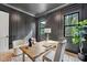 This home office features dark gray walls with paneling, a light wood desk, and plentiful natural light at 3832 Noremac Dr, Raleigh, NC 27612