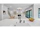 A large kitchen island with a sink overlooks the bright and airy living space with a fireplace and lots of light at 3832 Noremac Dr, Raleigh, NC 27612