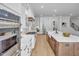 Bright, open kitchen with stainless steel appliances, wood floors and a large kitchen island with a farmhouse sink at 3832 Noremac Dr, Raleigh, NC 27612