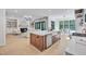 Modern kitchen with a large island, stainless steel appliances, and an open view to the living room at 3832 Noremac Dr, Raleigh, NC 27612