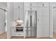 Bright kitchen boasts stainless steel appliances, custom cabinets, and an adjacent pantry with a stainless refrigerator at 3832 Noremac Dr, Raleigh, NC 27612