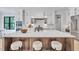 Stylish kitchen with white cabinets, a large island, and seating for three at 3832 Noremac Dr, Raleigh, NC 27612