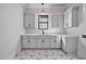 Well-lit laundry room featuring stylish cabinetry, modern fixtures, and a geometric-patterned floor, offering a functional and elegant space at 3832 Noremac Dr, Raleigh, NC 27612