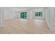 Spacious living room featuring hardwood floors, modern light fixture, and large windows offering ample natural light at 3832 Noremac Dr, Raleigh, NC 27612