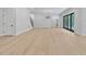 Bright living room with hardwood floors, modern lighting, and sliding glass doors leading to an outdoor space at 3832 Noremac Dr, Raleigh, NC 27612