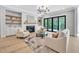 Cozy living room with a fireplace, built-in shelves, and a sliding glass door to the outside at 3832 Noremac Dr, Raleigh, NC 27612