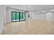 A large living room features hardwood floors and a large sliding glass door with nature view at 3832 Noremac Dr, Raleigh, NC 27612
