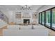 Spacious living room with a fireplace, built-in shelves, and a sliding glass door to the outside at 3832 Noremac Dr, Raleigh, NC 27612