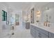 Main bathroom with marble floor, double vanity, glass-enclosed shower, and soaking tub at 3832 Noremac Dr, Raleigh, NC 27612
