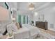 Bright main bedroom with tray ceiling, decorative rug, and balcony access at 3832 Noremac Dr, Raleigh, NC 27612