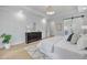 Bright main bedroom with tray ceiling, decorative rug, and ensuite bath access at 3832 Noremac Dr, Raleigh, NC 27612