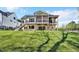 Beautiful backyard featuring a raised deck and screened-in porch with a grassy hillside at 3832 Noremac Dr, Raleigh, NC 27612