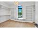 Spacious walk-in closet boasts custom shelving, natural light, and room for organization at 3832 Noremac Dr, Raleigh, NC 27612