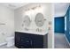 Bathroom featuring a double sink vanity with a quartz countertop and modern fixtures at 3900 Inkberry Ct, Apex, NC 27539