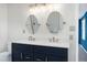 Modern bathroom with a double sink vanity, quartz countertops, and updated lighting at 3900 Inkberry Ct, Apex, NC 27539