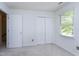 Carpeted bedroom with closet, window providing natural light, and painted white walls at 3900 Inkberry Ct, Apex, NC 27539