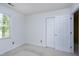 Carpeted bedroom with closet, window providing natural light, and painted white walls at 3900 Inkberry Ct, Apex, NC 27539