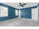Well-lit bedroom with a ceiling fan, three windows, and a closet door at 3900 Inkberry Ct, Apex, NC 27539