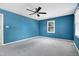 Bright bedroom with neutral carpet, painted blue walls, and ceiling fan at 3900 Inkberry Ct, Apex, NC 27539