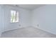 Bright bedroom featuring neutral carpet, window, and painted white walls at 3900 Inkberry Ct, Apex, NC 27539