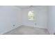 Bright bedroom featuring neutral carpet, window, and painted white walls at 3900 Inkberry Ct, Apex, NC 27539