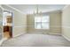 Dining room featuring neutral carpet, light yellow walls, white trim, and a chandelier light fixture at 3900 Inkberry Ct, Apex, NC 27539
