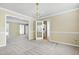 Bright dining room featuring neutral carpet, chandelier, and classic trim detail at 3900 Inkberry Ct, Apex, NC 27539
