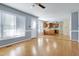 Open-concept living area with wood laminate flooring and direct access to a functional kitchen at 3900 Inkberry Ct, Apex, NC 27539