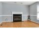 Cozy living room featuring an attractive fireplace and wood laminate flooring at 3900 Inkberry Ct, Apex, NC 27539