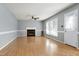 Comfortable living room with a ceiling fan, natural light, and an inviting fireplace at 3900 Inkberry Ct, Apex, NC 27539