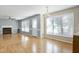 Open living area featuring wood laminate flooring, great natural light, and cozy fireplace at 3900 Inkberry Ct, Apex, NC 27539