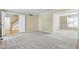 Open concept living room featuring neutral carpet and light yellow walls with white trim at 3900 Inkberry Ct, Apex, NC 27539