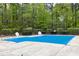 Community pool covered for the off season surrounded by mature trees and greenery providing shade and privacy at 3900 Inkberry Ct, Apex, NC 27539