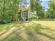Expansive backyard showcasing a screened porch, deck, and lush greenery for ultimate relaxation and outdoor living at 3900 Maplefield Dr, Raleigh, NC 27613