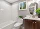 Bright bathroom features a tiled shower and a stylish vanity at 3900 Maplefield Dr, Raleigh, NC 27613
