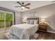 Bedroom with a ceiling fan, hardwood floors, and a sliding glass door at 3900 Maplefield Dr, Raleigh, NC 27613