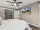 Cozy bedroom featuring a ceiling fan, TV, and walk-in closet with built-in shelving for optimal storage at 3900 Maplefield Dr, Raleigh, NC 27613