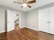 This bedroom has hardwood floors, a ceiling fan, and an closet space at 3900 Maplefield Dr, Raleigh, NC 27613
