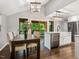 Dining area with hardwood floors, vaulted ceiling and views to screened in porch at 3900 Maplefield Dr, Raleigh, NC 27613
